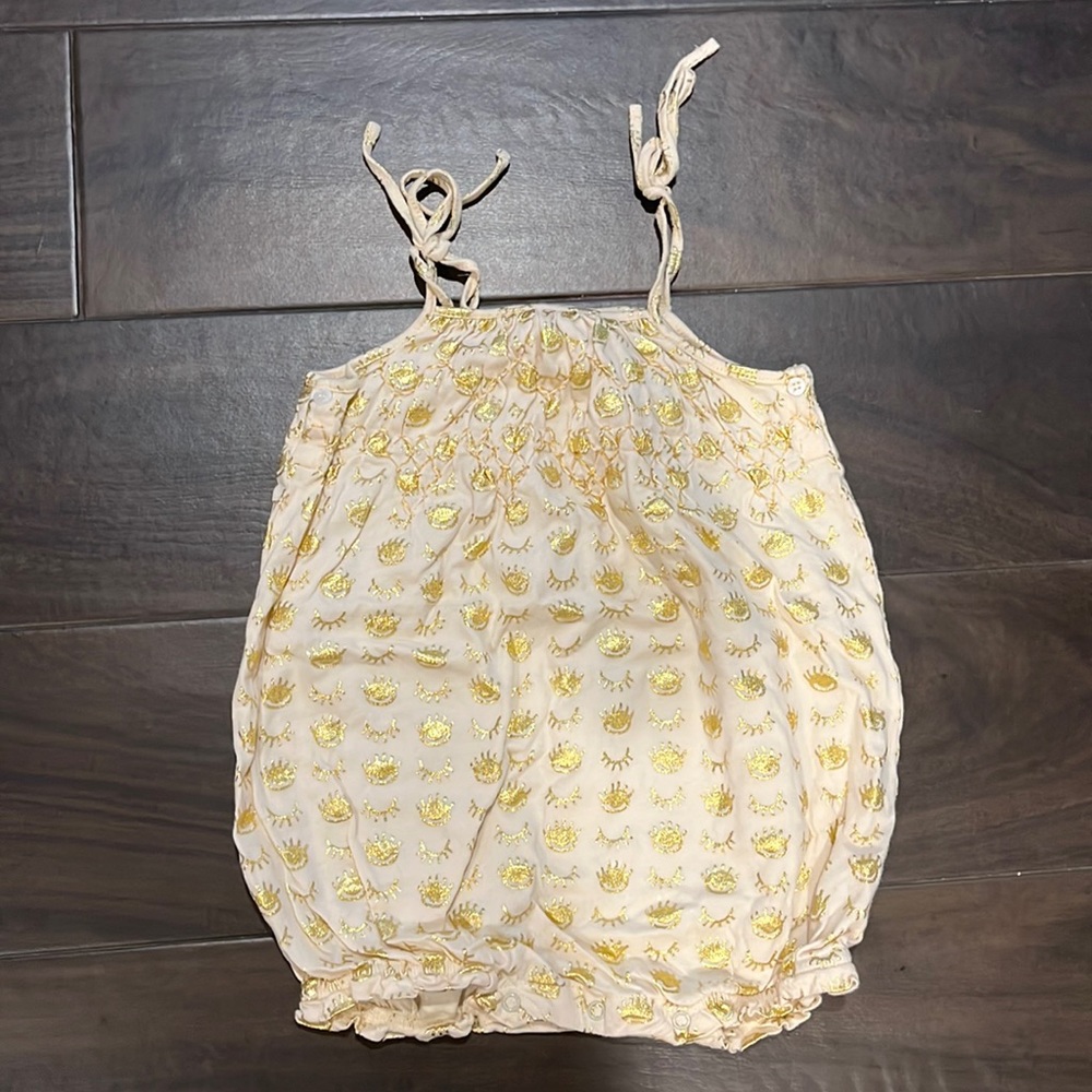 Cutest little boho onesie with gold eyes